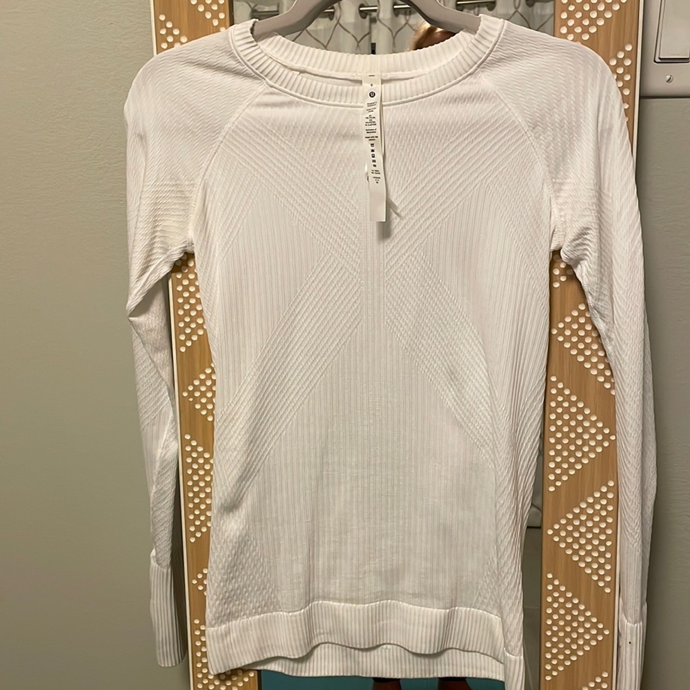 Fitted white long sleeve base layer.